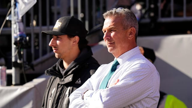 Former Ohio State Buckeyes head coach Urban Meyer watches from the sideline during the first half of the NCAA football game between the Buckeyes and the Michigan Wolverines at Ohio Stadium.